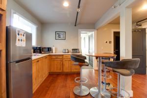 a kitchen with a stainless steel refrigerator and bar stools at Sisters Retreat Upper Lower in Sisters