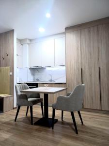 a dining room with a table and two chairs at MN apartman in Banja Luka +10 photos