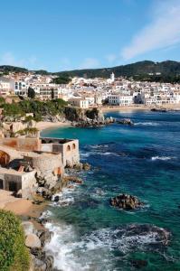 a view of a beach with buildings and the ocean at Nature House in Maçanet de la Selva