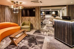 a living room with a couch and a television at Crowne Plaza Manchester Airport by IHG in Manchester Airport
