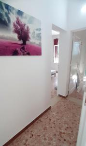 a white room with a painting on the wall at The house of the islands Sea view in Marausa +104 photos