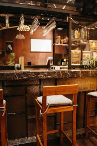 a bar with a chair in front of a counter at Auckland Boutique Capsule in Auckland