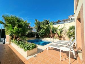 a patio with a chair and a swimming pool at Stunning Home with Outdoor Swimmingpool, 4 Bedrooms and Wifi in Benalmádena