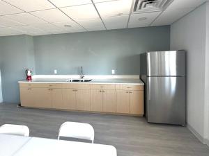 a kitchen with a stainless steel refrigerator in a room at #903 Panoramic Ocean View at Lovers Key Beach Club in Fort Myers Beach