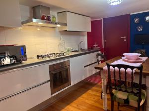 a kitchen with a table and a counter top at a casa di Emma in Grosseto
