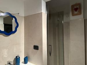 a bathroom with a shower and a mirror at a casa di Emma in Grosseto