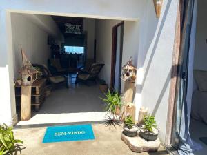 a view of a room with plants and a doorway at Suites Frente ao Mar in Prado