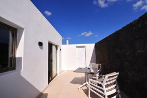 a dining room with a table and two chairs at Nicole Home in Playa Blanca