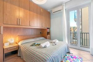 a bedroom with a bed with towels on it at Domus 21 Near Alassio Beach - Happy Rentals in Alassio