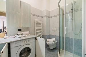 a bathroom with a washing machine and a toilet at Domus 21 Near Alassio Beach - Happy Rentals in Alassio