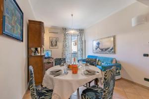 a living room with a table and chairs and a couch at Domus 21 Near Alassio Beach - Happy Rentals in Alassio +16 photos
