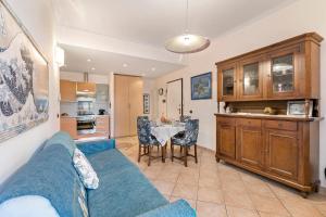 a living room with a blue couch and a table at Domus 21 Near Alassio Beach - Happy Rentals in Alassio