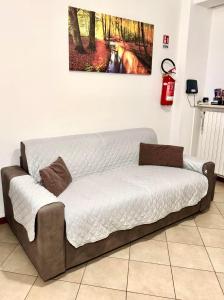 a couch in a room with a painting on the wall at Top Apartment in Beccacivetta