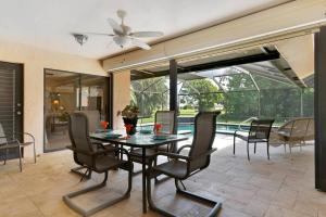 a dining room with a table and chairs at New lanai! Electric-heated pool home with spa in quiet neighborhood - Villa Milano in North Fort Myers