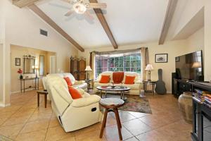 a living room with a couch and a table at New lanai! Electric-heated pool home with spa in quiet neighborhood - Villa Milano in North Fort Myers