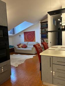a kitchen with a living room with a couch at Residenza Il Carducci in Bergamo +11 photos