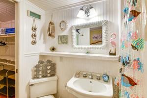 a bathroom with a sink and a toilet and a mirror at Less Than 1 Mi to Boat Ramp Canal-Front Retreat in Astor! in Astor +30 photos