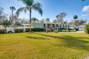 a house with a palm tree and a yard at Less Than 1 Mi to Boat Ramp Canal-Front Retreat in Astor! in Astor