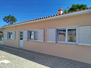 a house with white shutters on a street at Cosy Home Santana in Santana