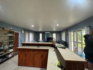 a large kitchen with a counter top and a counter sidx sidx sidx at Anas place Siusega in Vaitele