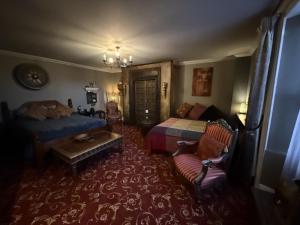 a bedroom with a bed and a couch at The Covenstead in Glastonbury