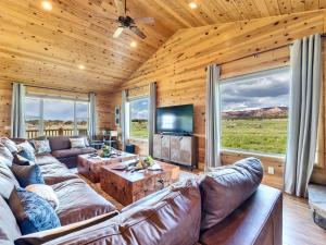 a living room with a large couch and a tv at Bryce Canyon Retreat in Hatch +37 photos
