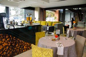 a restaurant with two tables and chairs and a counter at City Living Boutique Hotel in Bloemfontein