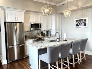 a kitchen with a stainless steel refrigerator and a counter at The Frenchman 2bed - 2 bath in New Orleans +6 photos