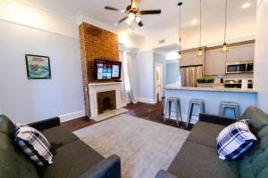 a living room with a couch and a fireplace at Claiborne Historic Victorian Mansion B - 5 bed-3 bath in New Orleans