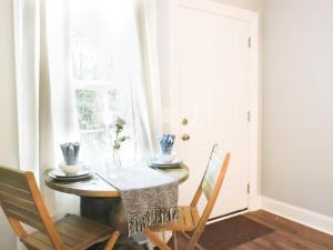 a dining room with a table and chairs and a window at Charming St. Ann Studio in New Orleans
