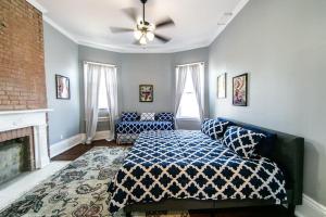 a living room with a bed and a fireplace at Claiborne Historic Victorian Mansion B - 5 bed-3 bath in New Orleans