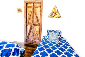 a room with a bed and a wooden door at Historic Treme Creole Cottage 3 bed-2 bath (C) in New Orleans +6 photos