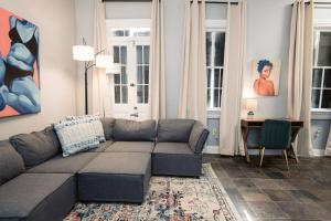 a living room with a couch and a table at Monthly - Dumaine Historic Carriage House in New Orleans