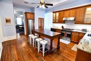 a kitchen with a wooden table and stools at Villere Historic Mansion in New Orleans +33 photos