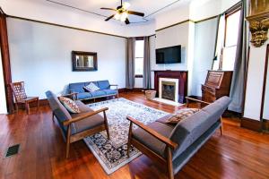 a living room with a couch and a fireplace at Claiborne Historic Mansion - 5 bed-3bath in New Orleans