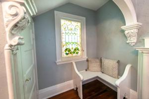 a room with a window and a white bench at Claiborne Historic Mansion - 5 bed-3bath in New Orleans