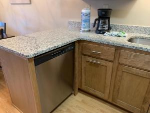a kitchen with a sink and a dishwasher at Gatlinburg Village 503 by Olde Gatlinburg Rentals in Gatlinburg +18 photos