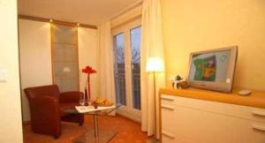 a living room with a chair and a window at Aqua Marina in Helgoland