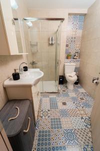 a bathroom with a sink and a toilet at Ioannina Center Apartment in Ioannina +37 photos