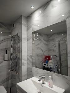 a bathroom with a sink and a mirror at Dom Lawendowy in Lubasz
