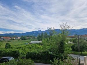 a view of a field with mountains in the background at Paradiso al mare in Marina di Massa