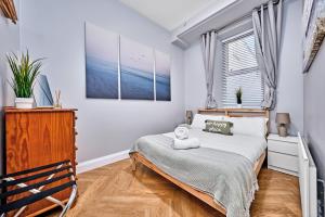 a bedroom with a bed and a window at Dunluce Park 1 - Dog friendly - Portrush by the Sea in Portrush
