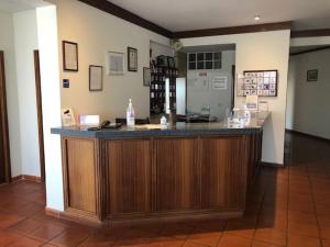 a lobby with a large wooden bar in a room at HOTEL CRUZ DA MATA in Mangualde