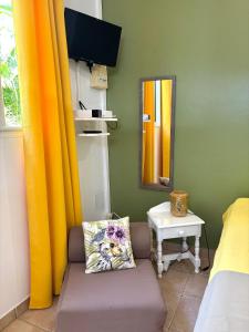 a room with a couch and a mirror and a table at Gîte Mabouya - Hamac, Piscine, Jardin in Anse-Bertrand +12 photos
