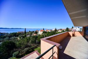 a balcony of a house with a view of the water at Apartments Ivan in Zadar