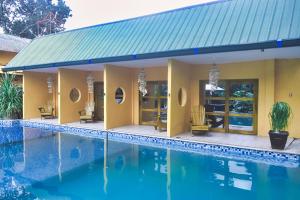 a house with a swimming pool in front of it at P1 Club Resort in Panglao Island