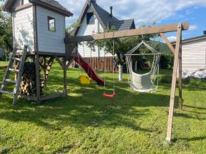 a playground with a play house and a slide at Cabana Apple Garden Rășinari in Răşinari