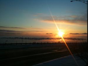 a sunset over a road with the sun in the sky at Auberge La Marmite in La Malbaie +30 photos