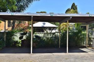 a pavilion in front of a house at Traveller's Palms no 8 - Bring your own linen. in South West Rocks