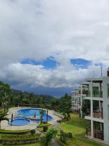 a resort with a large swimming pool next to a building at Lakeview suites condo in Tagaytay